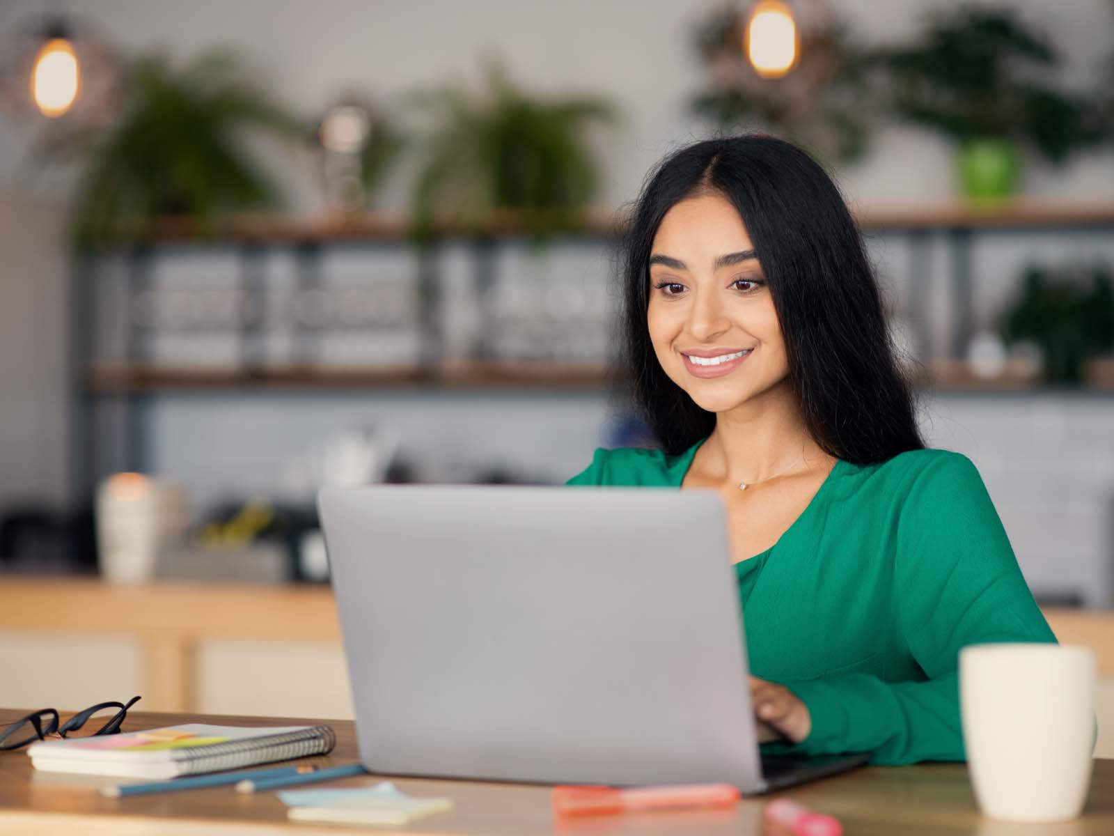 A mature student smiling at her work.