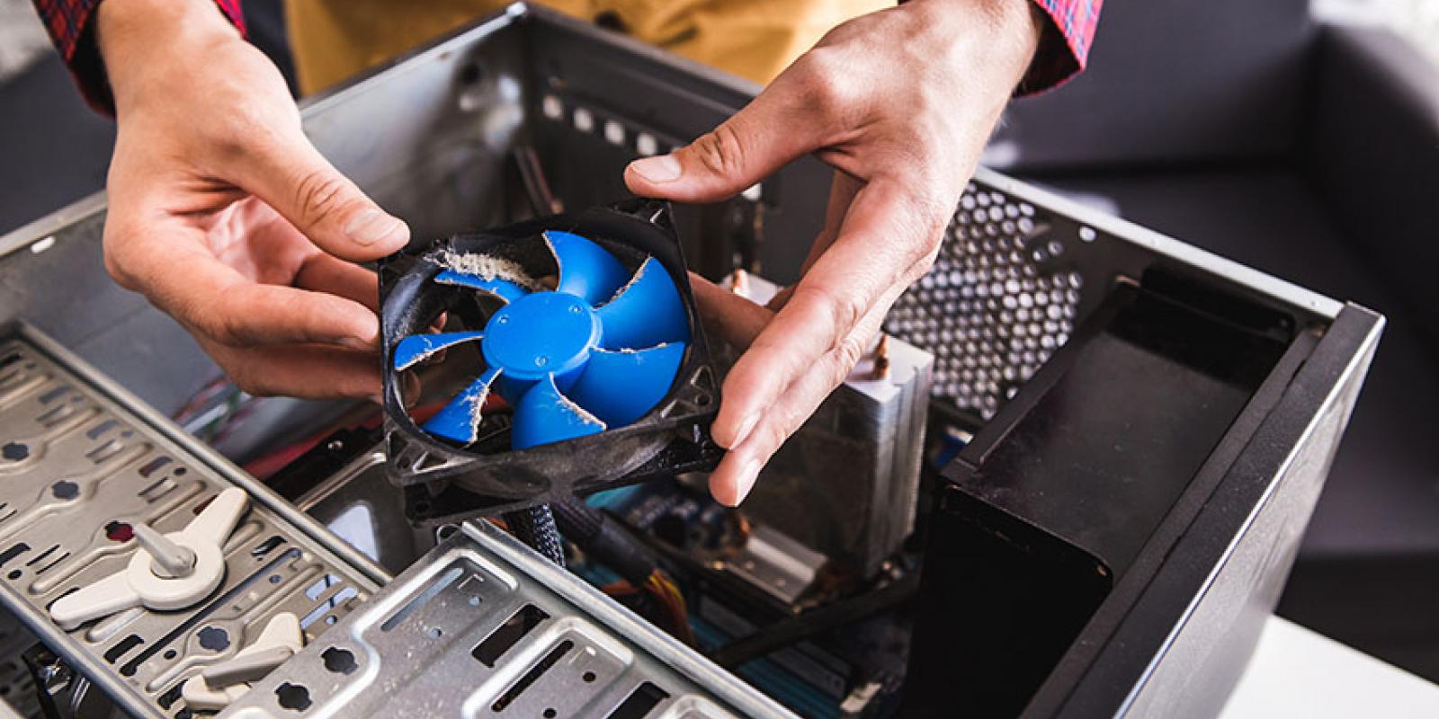 Dirt computer fan being cleaned