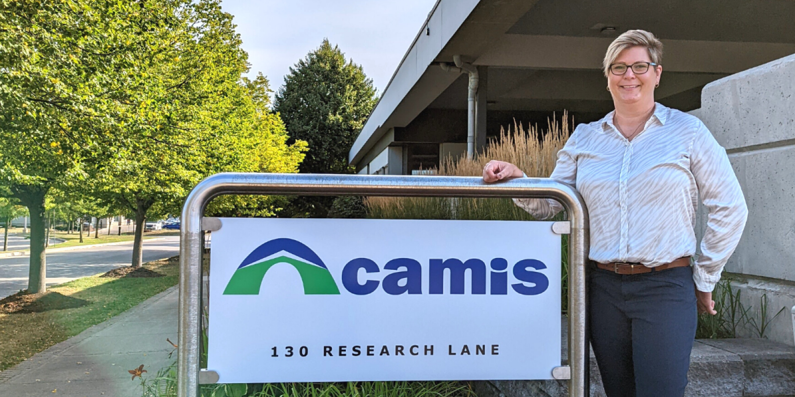 New CEO Kim Mackie with Camis sign