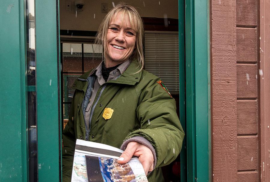 Woman handing out map at gatehouse