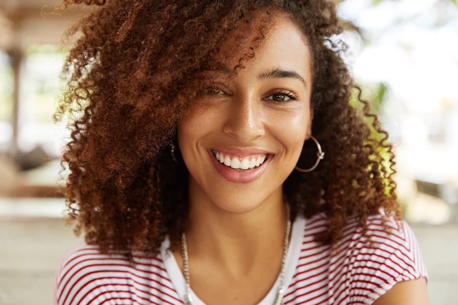 Woman of brown skin smiling