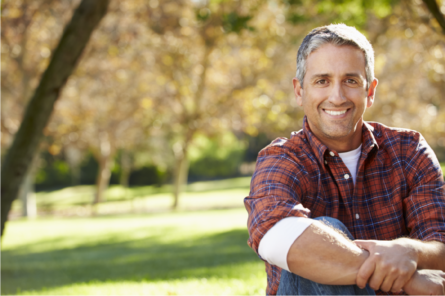 A man smiling while enjoying the outdoors.