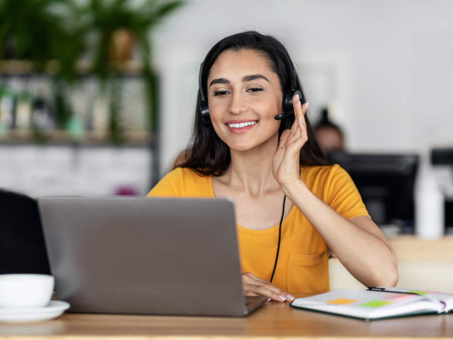 A student smiling as she answers a call for work.